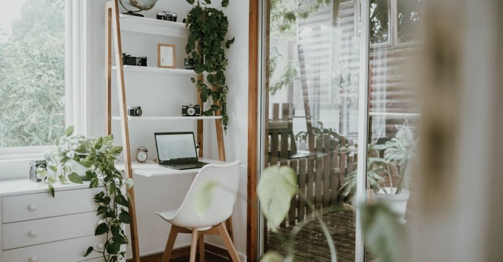 Minimalist home office with Scandinavian design, featuring greenery and natural light.