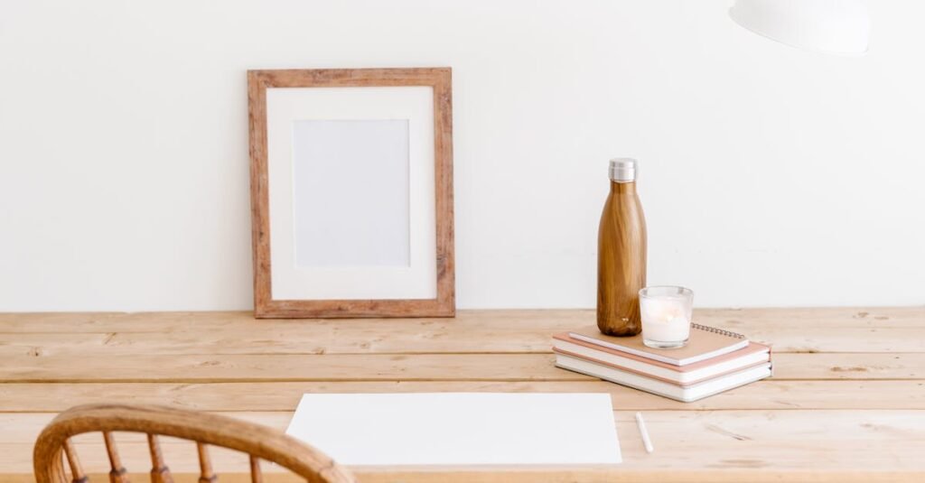 Minimalist workspace featuring a wooden chair, desk, frame, and bottle. Perfect for a calm office setting.